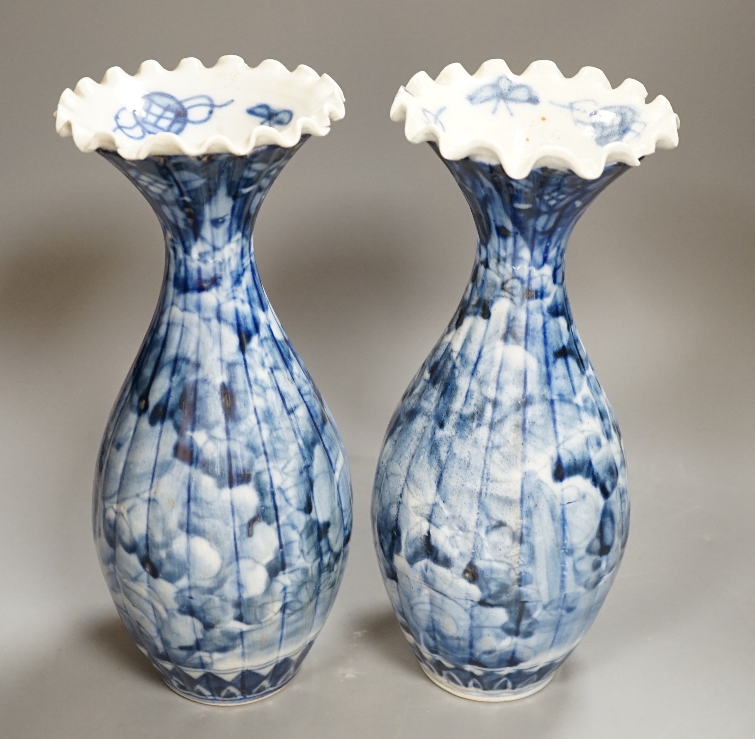 A pair of early 20th century Japanese fluted blue and white flared rim vases, 31.5cm